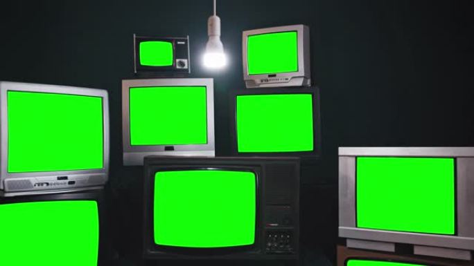 一组9台老式电视，带色度键屏幕，房间内有蓝色黑色墙壁