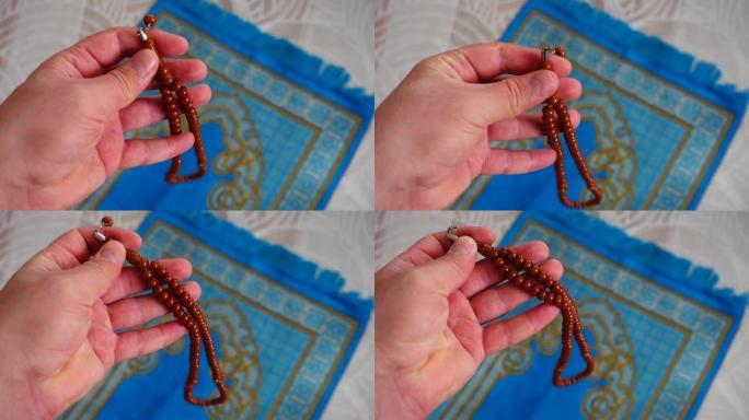 房子里有一个穆斯林的蓝色祈祷地毯，他的念珠，旁边是一个祈祷地毯，用于伊斯兰教的礼拜，