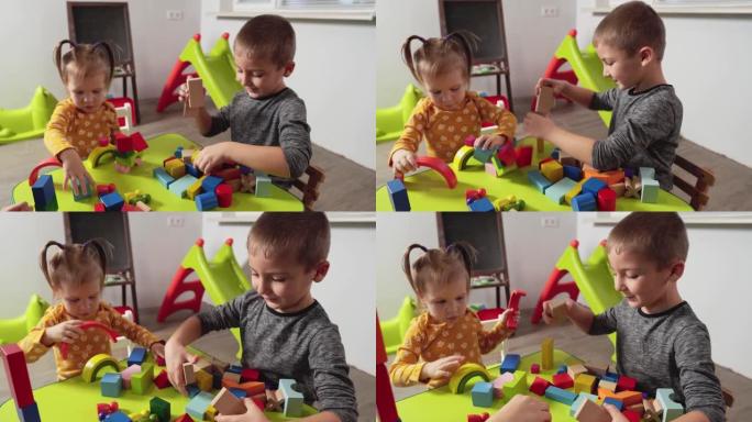 孩子们玩五颜六色的积木。幼儿园不同年龄的孩子玩游戏，发展逻辑思维。