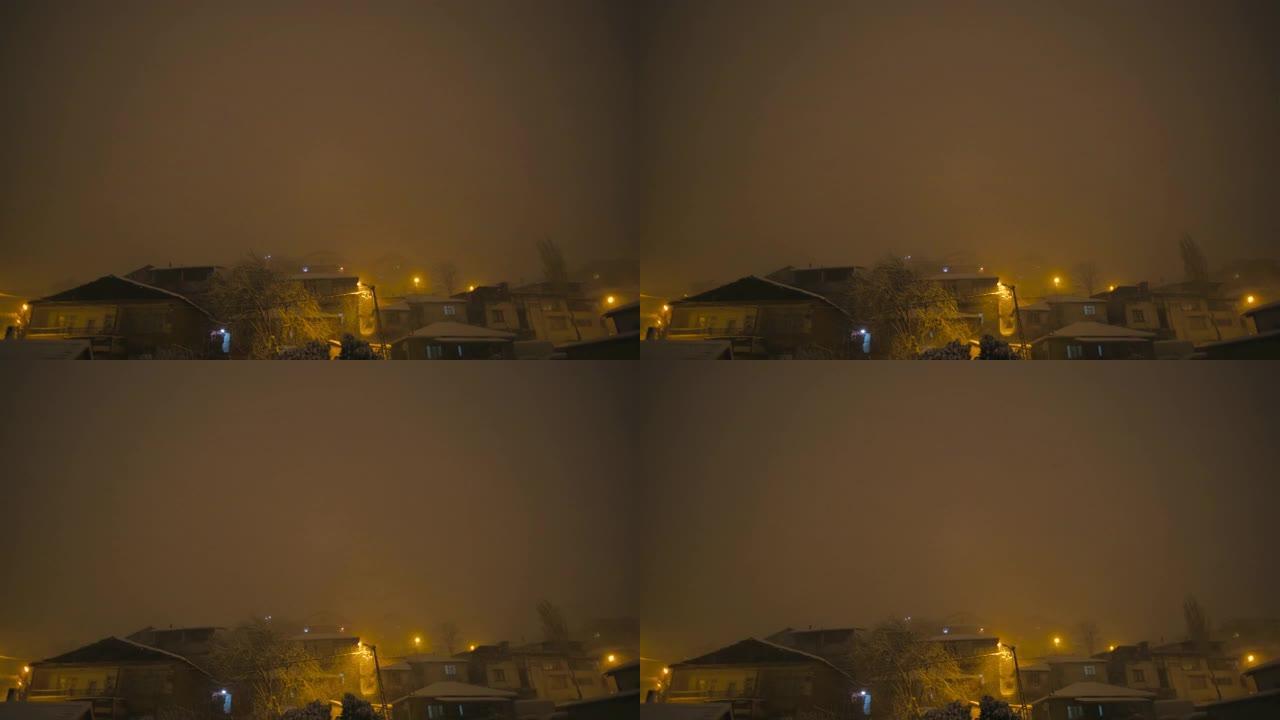 伊斯坦布尔贫民窟地区夜间大雪和橙色天空