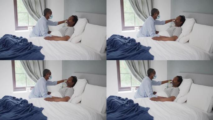 4k视频片段，一个成熟的男人在家里的床上被妻子测体温时看起来不舒服