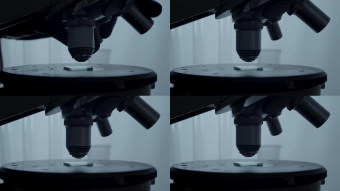 显微镜设置在载玻片上的特写镜头。在科学实验室工作。学校科学项目。
