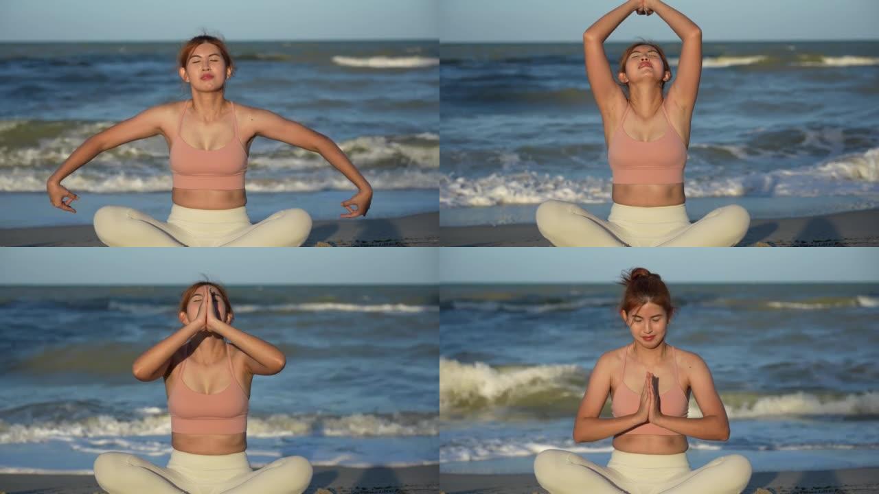 亚洲女性在海水附近的海滩上闲逛和做瑜伽，背景是海浪，日落时在海边冥想，使她的头脑平静而平静。