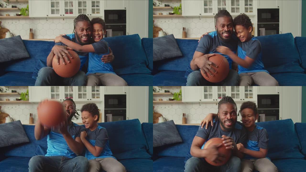 喜出望外的非洲父亲和男孩看电视和欢呼篮球比赛