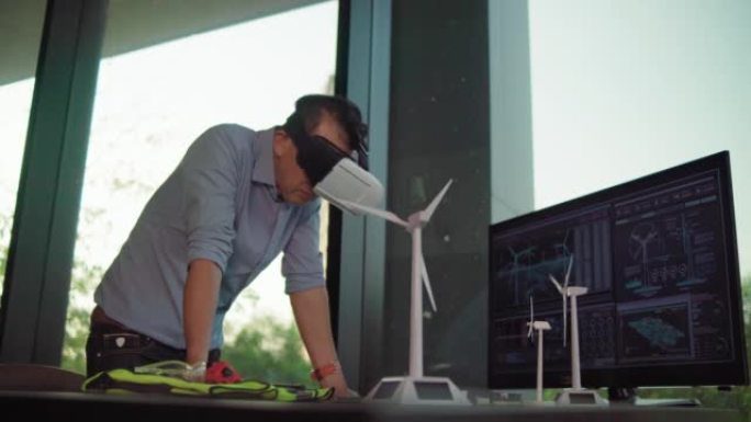 戴着虚拟现实眼镜的工程师使用未来派全息图来创建带有风力涡轮机的替代能源解决方案