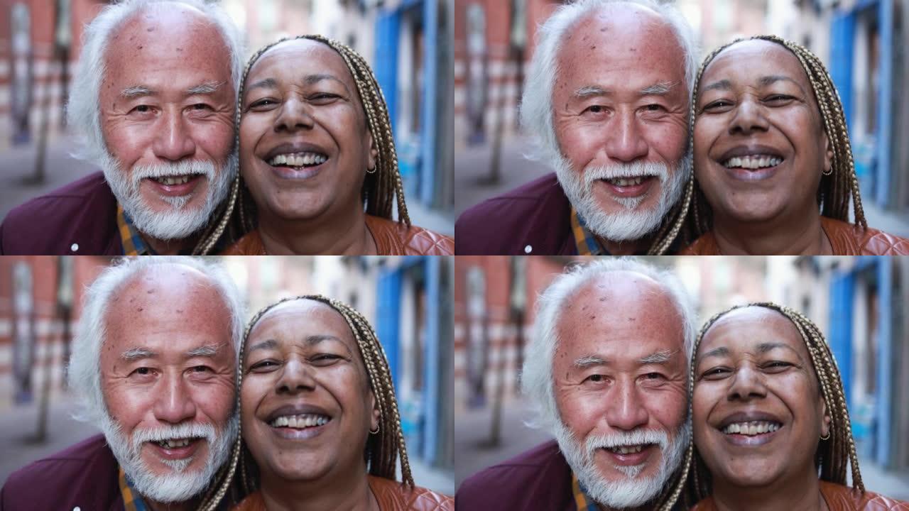 多种族的高级夫妇在户外相机上微笑