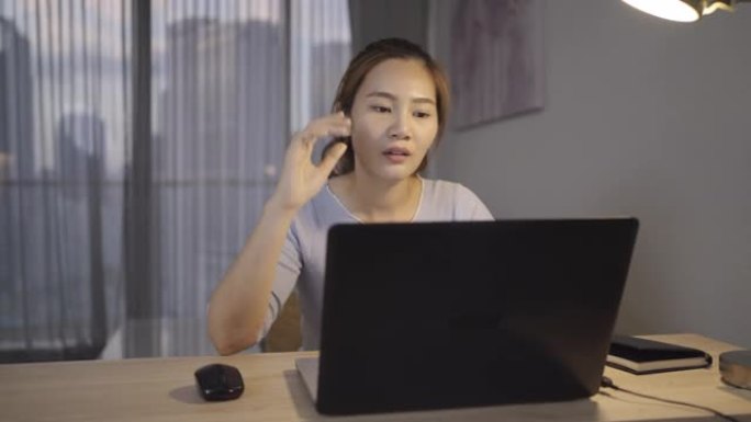 亚洲妇女在深夜工作时压力很大，在家庭办公室的笔记本电脑或笔记本电脑上存在项目研究问题。