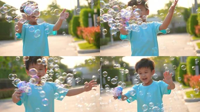 亚洲孩子在公园玩泡泡。幸福与夏天的概念