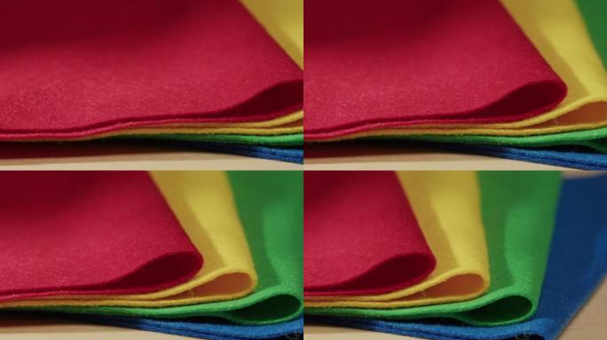 柔软的彩色毛毡，红色，黄色，绿色和蓝色材料。毛毡织物表面纹理抽象背景不同颜色