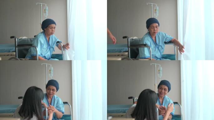 癌症患者妇女戴着头巾和她的支持女儿在医院，健康和保险的概念