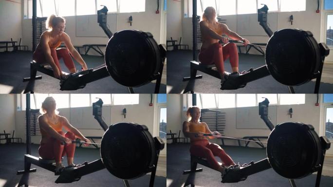 高加索女运动员在健身房的划船机上锻炼