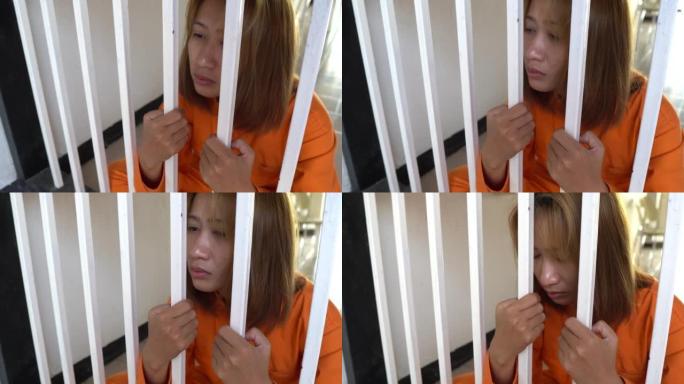 女囚犯坐在牢房里，看上去很绝望。