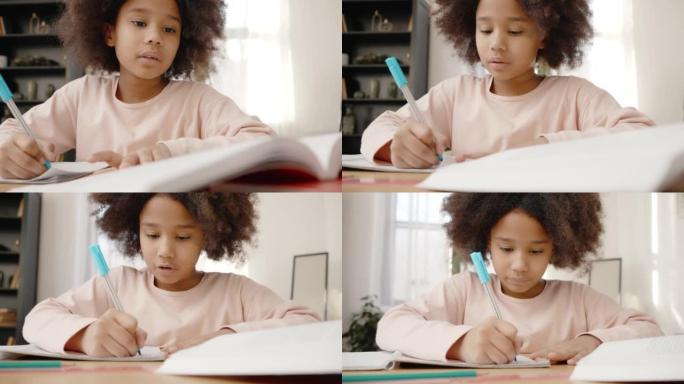在家进行早期教育。聪明的小非洲裔美国女孩在家训练，在抄本上写文字，跟踪镜头