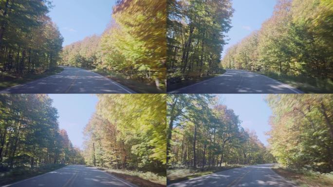 沿着弯曲的秋季森林路行驶
