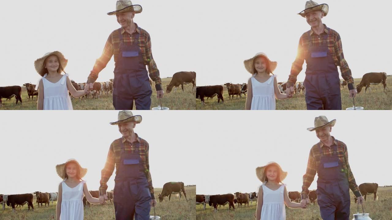 微笑的农民和小女孩在日落时分走在夏天的田野里