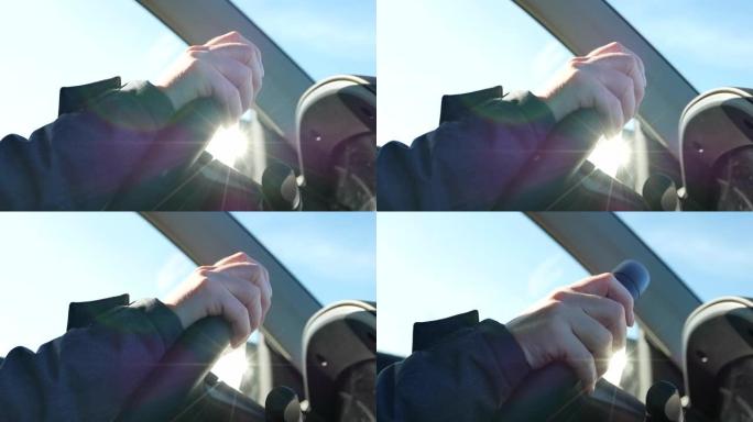 驾驶汽车时女性手在方向盘上的特写