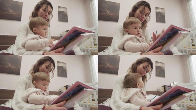 育儿。妈妈在家给宝宝看书。