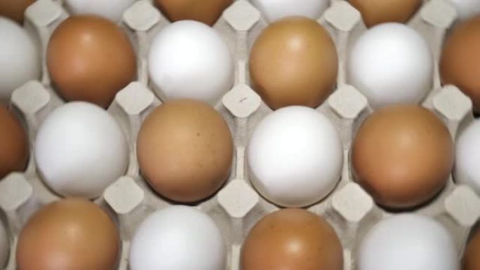 鸡蛋旋转，俯视图。托盘里的生鸡蛋。复活节彩蛋背景