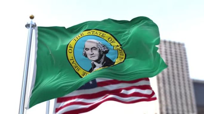 美国华盛顿州的旗帜在风中飘扬，背景是模糊的美国国旗