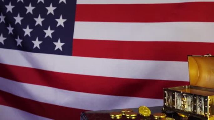 金币落入美国国旗背景下的胸部。