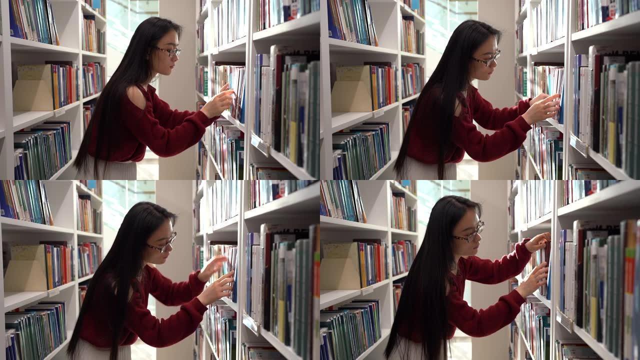 日本学生女孩在大学图书馆寻找书籍，为课程工作挑选小说或材料
