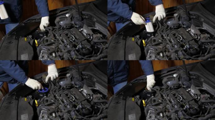 汽车修理工在汽车上安装了新的燃油滤清器。燃油滤清器更换和燃油系统维护，特写
