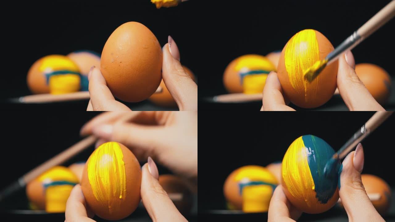 女孩用黄蓝颜料画复活节彩蛋