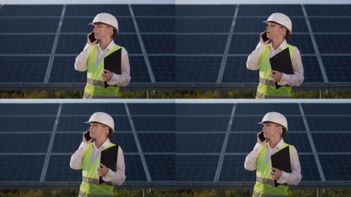 女工程师在太阳能站之间用手机交谈。