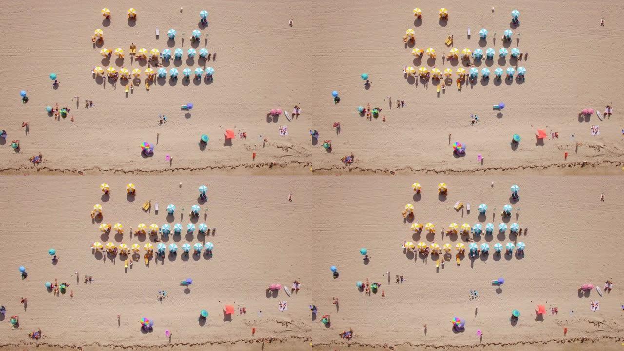 在美国佛罗里达州迈阿密的南海滩，色彩丰富的沙滩伞和人们享受夏天的俯视图
