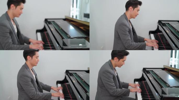 穿着休闲服的男钢琴家在家演奏经典三角钢琴的特写镜头。享受音乐和放松。音乐家在练习钢琴时很开心。在线学