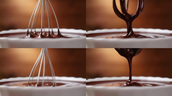 在厨房中将融化的液体巧克力与钢搅拌器近距离混合。热巧克力混合漩涡和滴在木制背景的白色碗。烹饪手工巧克