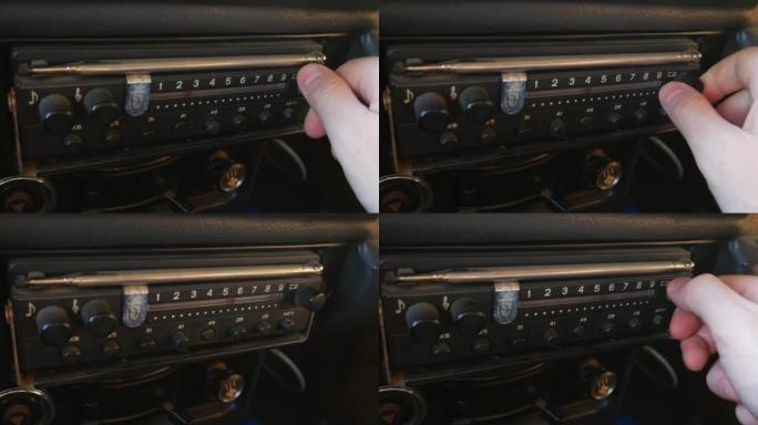 旧收音机是通过转动车内的拨盘来调谐的。收音机拨打号码，寻找电台。苏联的旧收音机。人手