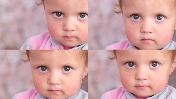 一个愤怒的小孩的特写肖像，她看着相机很难过。沉思的孩子没有