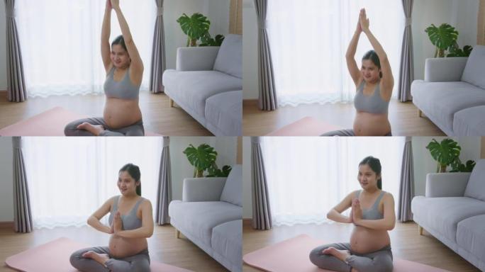 年轻孕妇在家做瑜伽，保健和怀孕护理概念