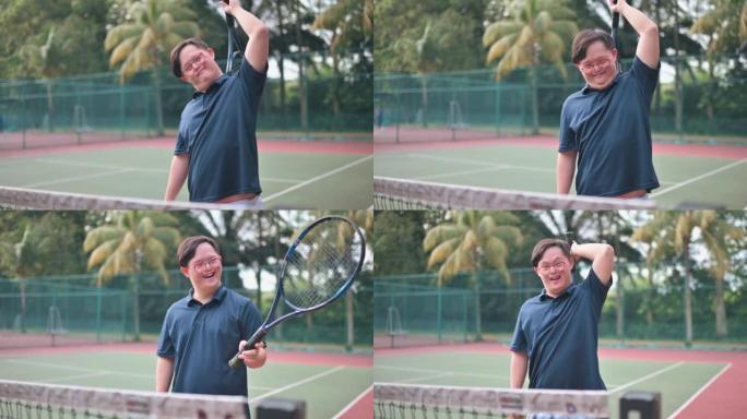 亚洲华人唐氏综合症在网球场微笑着用网球拍挠背