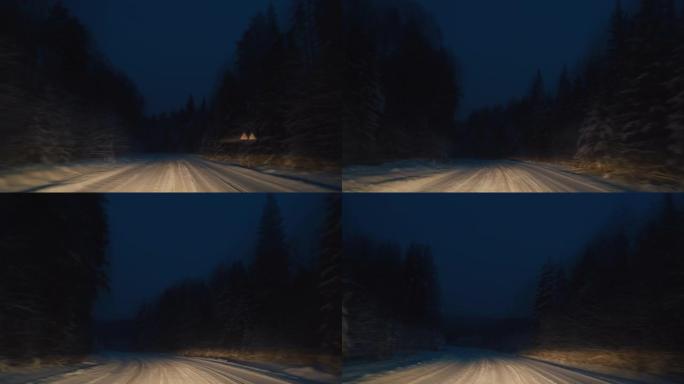 森林道路视点。摄像机在傍晚时分沿着冬季森林中的狭窄道路移动，道路被汽车的前灯突出显示