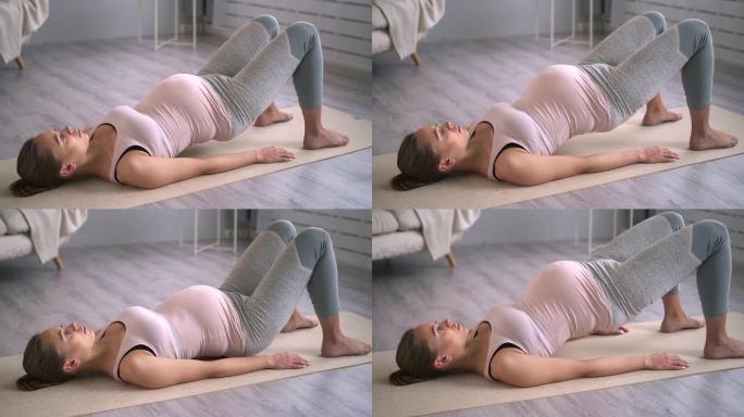 孕妇在家用提臀运动瑜伽。Spbd。有产前身体和肚子的妈妈。女性