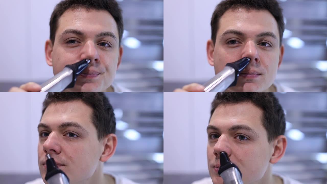 用舒适的电动修剪器帮助男人去除鼻毛的特写脸