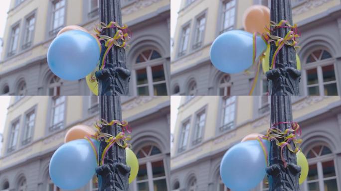 恶劣天气街头派对 -- 路灯柱子上的气球和彩带