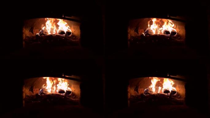 火柴在俄罗斯的炉子里燃烧。在火烧的烤箱里烹饪食物。烤箱中在煤上的铝箔油炸肉