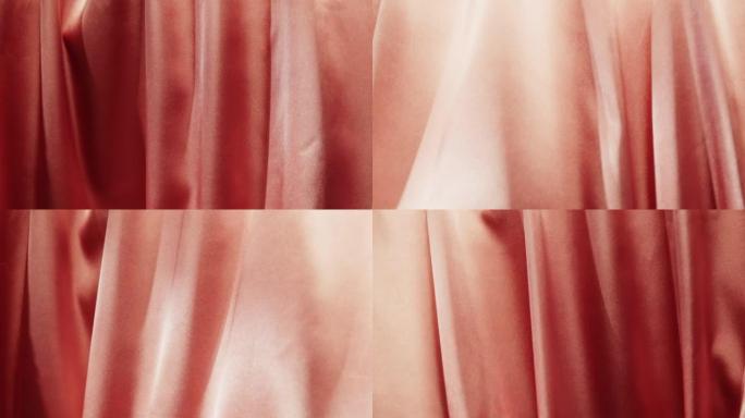 粉色丝绸特写，橙色缎面奢华布料纹理背景。豪华设计纺织品