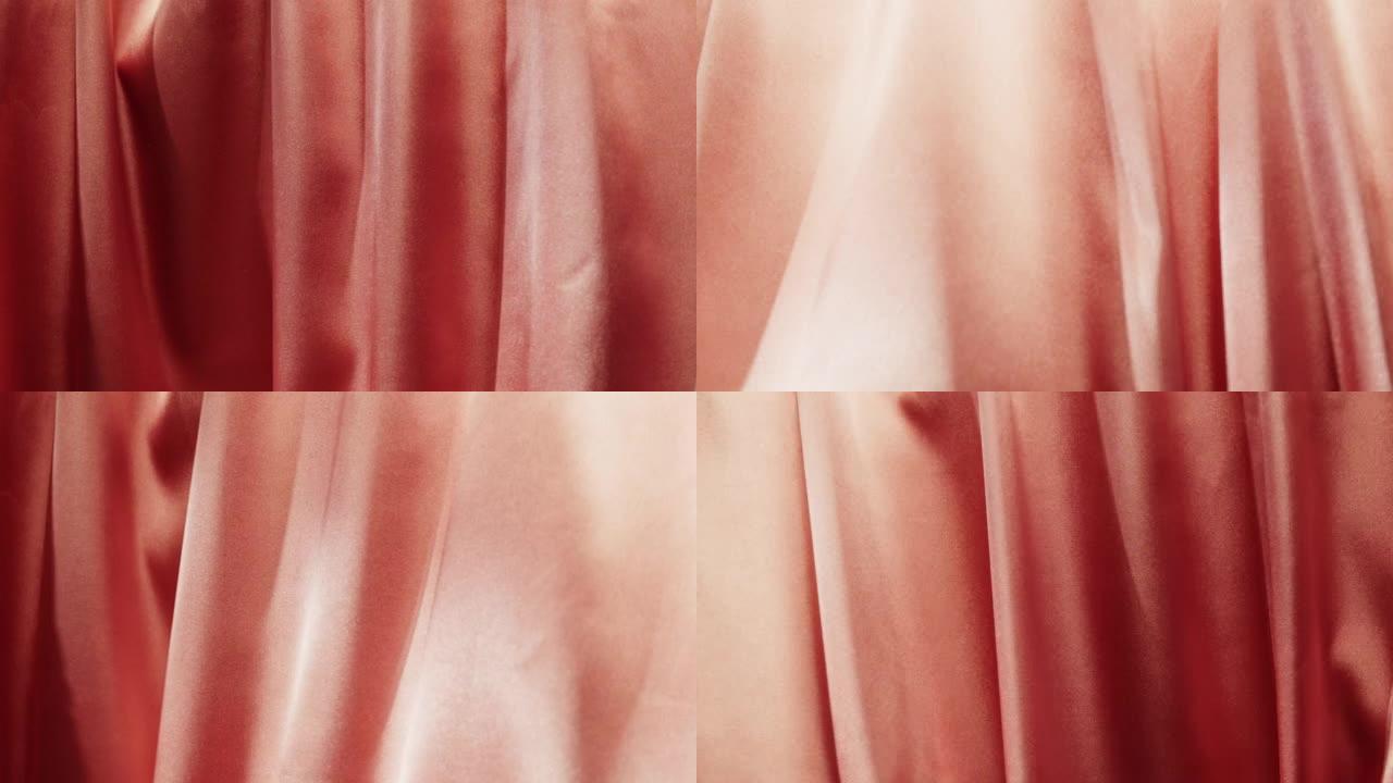 粉色丝绸特写，橙色缎面奢华布料纹理背景。豪华设计纺织品