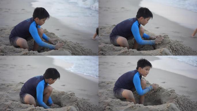 亚洲男孩兄弟在日落时在海滩上享受和玩海和沙子
