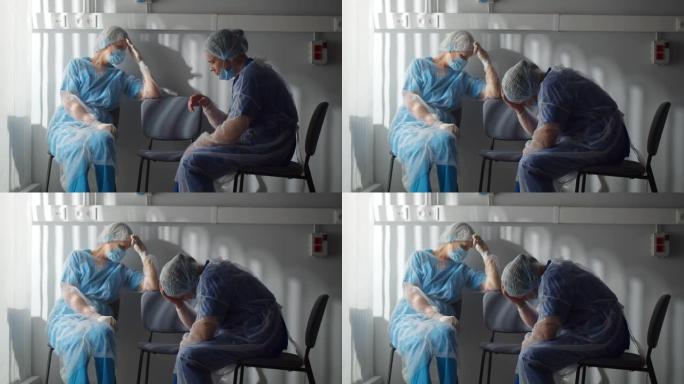 穿着无菌长袍和安全面罩的疲惫的外科医生坐在病房的椅子上休息