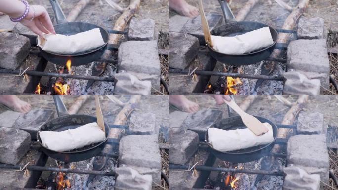 在户外准备用皮塔饼包裹的肉沙威玛，在锅里燃烧篝火。4K