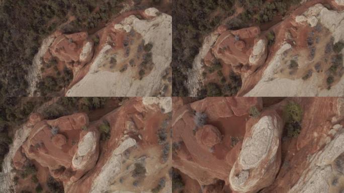 在干旱的科罗拉多州气候沙漠中向下移动空中透视砂岩露头和侵蚀的岩石表面冬季晚风暴云层视频系列