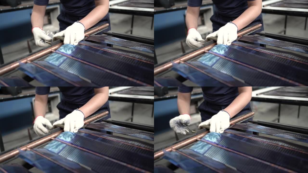 太阳能电池板工厂的非裔美国人组装面板的特写