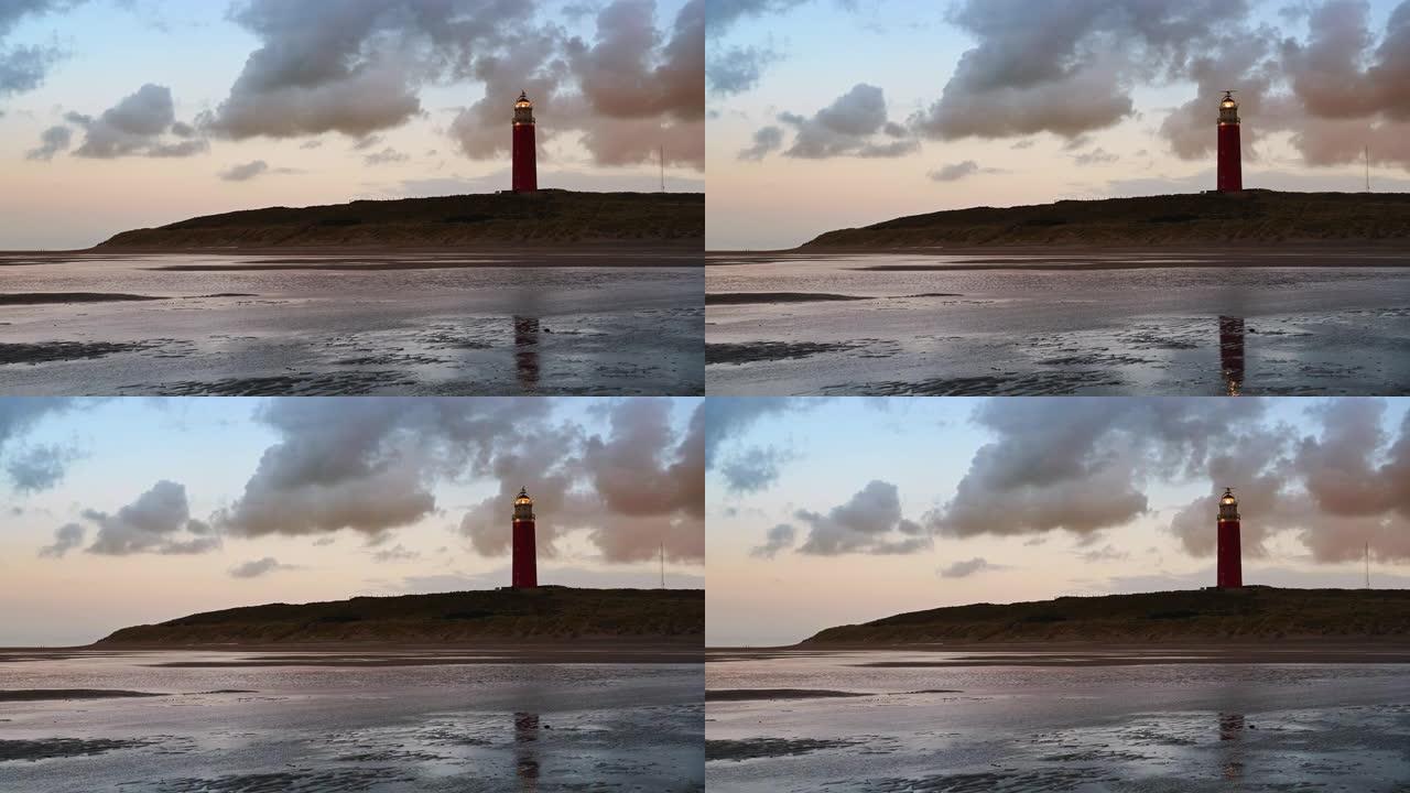 风雨如磐的秋日过后，日落时分，沙丘中瓦登岛特塞尔 (Wadden island Texel) 的灯塔