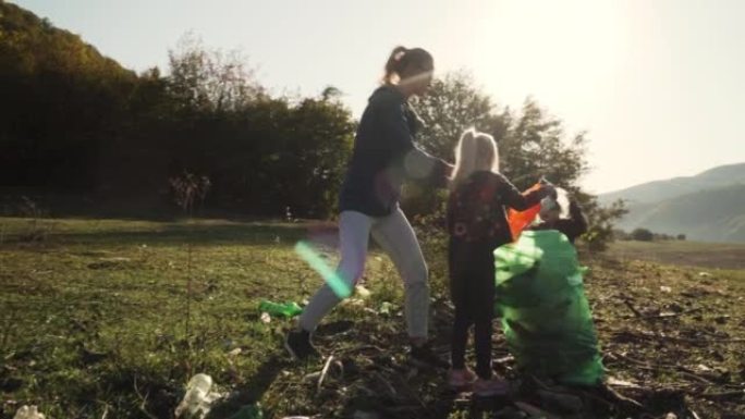 高加索家庭在日出时清洁充满垃圾的土地