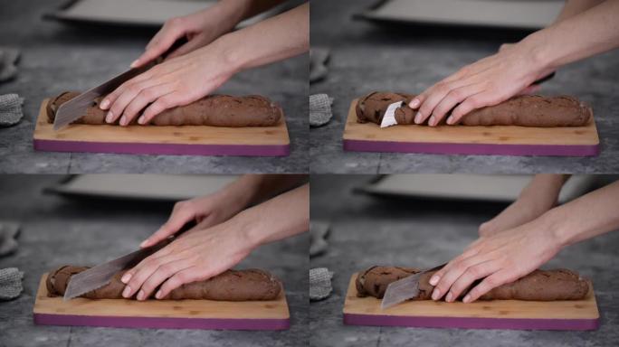巧克力榛子biscotti饼干，用锯齿刀切割，在木板上。
